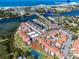Aerial view showing tennis court, pool, and bay at 1602 Stickney Point Rd # 305, Sarasota, FL 34231
