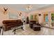 Spacious living room featuring leather furniture and French doors leading to the patio at 3618 Palonia Ct, Sarasota, FL 34239