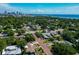 Aerial view of neighborhood near the water, featuring lush trees and various house styles at 150 21St S Ave, St Petersburg, FL 33705