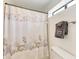 Clean bathroom with seashell shower curtain and towels at 6157 Midnight Pass Rd # C12, Sarasota, FL 34242
