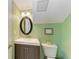 Clean bathroom with a vanity and oval mirror at 6157 Midnight Pass Rd # C12, Sarasota, FL 34242