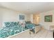 Guest bedroom with two twin beds and tropical bedding at 6157 Midnight Pass Rd # C12, Sarasota, FL 34242