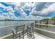Private dock with chairs overlooking the water at 6157 Midnight Pass Rd # C12, Sarasota, FL 34242