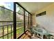 Screened balcony with glass table and chairs at 6157 Midnight Pass Rd # C12, Sarasota, FL 34242