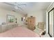 Spacious bedroom with a dresser, chair, and large window at 6157 Midnight Pass Rd # C12, Sarasota, FL 34242