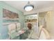 Bright dining area with a glass table and kitchen view at 6157 Midnight Pass Rd # C12, Sarasota, FL 34242