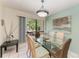 Charming dining room with glass table and wicker chairs at 6157 Midnight Pass Rd # C12, Sarasota, FL 34242