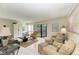 Spacious living room with ample seating, a coffee table, and access to a balcony at 6157 Midnight Pass Rd # C12, Sarasota, FL 34242