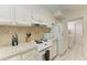 Efficient kitchen with ample storage and white appliances at 6157 Midnight Pass Rd # C12, Sarasota, FL 34242