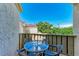 Balcony with a small table and chairs for outdoor dining at 6157 Midnight Pass Rd # C12, Sarasota, FL 34242