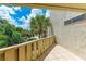 Private balcony overlooking lush tropical landscape at 6157 Midnight Pass Rd # C12, Sarasota, FL 34242