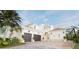A two-story house with a two-car garage, tile roof and palm trees at 3523 Trebor Ln, Sarasota, FL 34235