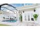 Inviting pool area with covered patio and lush landscaping at 3523 Trebor Ln, Sarasota, FL 34235