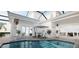 An outdoor pool area with a covered patio and dining furniture at 3523 Trebor Ln, Sarasota, FL 34235