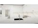Modern white kitchen with stainless steel appliances and marble counters at 3523 Trebor Ln, Sarasota, FL 34235