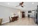 Open concept living and kitchen area with hardwood floors and ceiling fan at 1650 Pine Tree Ln # 103, Sarasota, FL 34236