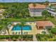 Community pool with lounge chairs and a covered area at 8755 Olde Hickory Ave # 7105, Sarasota, FL 34238