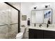 Well-lit bathroom features modern black fixtures, a double vanity, and a stylish glass-enclosed shower at 1450 Silvia Shores Dr, Apollo Beach, FL 33572