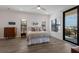 Bedroom with neutral decor, wood floors, and balcony at 1450 Silvia Shores Dr, Apollo Beach, FL 33572