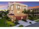Charming home with a 3-car garage, a red tile roof and lush landscaping at 1450 Silvia Shores Dr, Apollo Beach, FL 33572