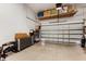 A well lit two car garage features storage shelf and room for parking at 1450 Silvia Shores Dr, Apollo Beach, FL 33572