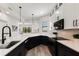 Bright kitchen with quartz countertops, stainless steel appliances, and elegant white and navy-blue cabinets at 1450 Silvia Shores Dr, Apollo Beach, FL 33572