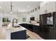 Modern kitchen features an island with seating and sleek stainless steel appliances at 1450 Silvia Shores Dr, Apollo Beach, FL 33572