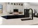 Bright, modern kitchen featuring quartz countertops, dark hardware, and stainless steel appliances at 1450 Silvia Shores Dr, Apollo Beach, FL 33572