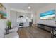 Modern living area with a kitchenette, featuring gray cabinets, stainless steel appliances and vinyl floors at 1450 Silvia Shores Dr, Apollo Beach, FL 33572
