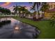Scenic pond featuring a fountain, manicured landscaping, creating a tranquil and inviting outdoor ambiance at 1450 Silvia Shores Dr, Apollo Beach, FL 33572