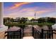 Sunset view of a tranquil pond framed by black metal railings, showcasing the vibrant colors of the sky at 1450 Silvia Shores Dr, Apollo Beach, FL 33572