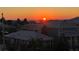 Waterfront homes under an orange sky at sunset are lined with palm trees at 1450 Silvia Shores Dr, Apollo Beach, FL 33572