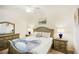 Cozy bedroom featuring a well-dressed bed, matching nightstands and lamps, and a dresser at 17704 Gawthrop Dr # 402, Bradenton, FL 34211