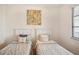 Bright bedroom featuring two twin beds, a window with blinds, and neutral decor at 17704 Gawthrop Dr # 402, Bradenton, FL 34211