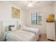 Bright bedroom featuring two twin beds, a window with blinds, and neutral decor at 17704 Gawthrop Dr # 402, Bradenton, FL 34211