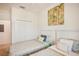 Bright bedroom featuring two twin beds, a window with blinds, and neutral decor at 17704 Gawthrop Dr # 402, Bradenton, FL 34211