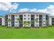 Scenic view of a well-maintained condo building with spacious balconies, surrounded by lush greenery and a tranquil pond at 17704 Gawthrop Dr # 402, Bradenton, FL 34211