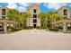 Elegant condominium building with lush landscaping, covered parking, and convenient accessibility features at 17704 Gawthrop Dr # 402, Bradenton, FL 34211