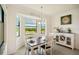 Dining area with natural light and scenic views of the lake and trees, complemented by stylish decor at 17704 Gawthrop Dr # 402, Bradenton, FL 34211