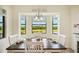 Dining area with natural light and scenic views of the lake and trees, creating a serene atmosphere at 17704 Gawthrop Dr # 402, Bradenton, FL 34211