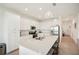 Bright, all-white kitchen features stainless steel appliances, quartz countertops, and an island with seating at 17704 Gawthrop Dr # 402, Bradenton, FL 34211
