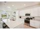 Bright, updated kitchen with stainless steel appliances, a center island and white cabinets at 17704 Gawthrop Dr # 402, Bradenton, FL 34211