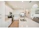 Bright, all-white kitchen features stainless steel appliances, quartz countertops, and an island with seating at 17704 Gawthrop Dr # 402, Bradenton, FL 34211