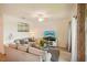 Bright living room with neutral tones, ceiling fan, and sliding glass door to balcony at 17704 Gawthrop Dr # 402, Bradenton, FL 34211