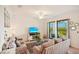 Comfortable living room featuring neutral decor and balcony access overlooking a scenic landscape at 17704 Gawthrop Dr # 402, Bradenton, FL 34211