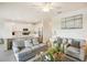 Open-concept living room flows to kitchen with pendant lights, breakfast bar, and tile flooring at 17704 Gawthrop Dr # 402, Bradenton, FL 34211