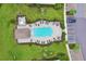 Aerial photo of a beautiful pool area surrounded by lounge chairs, landscaping, and parking spaces at 17704 Gawthrop Dr # 402, Bradenton, FL 34211