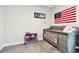Cozy Bedroom featuring gray carpet, crib, and wall decor at 5802 Alabaster Stone Ln, Apollo Beach, FL 33572