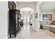 Spacious hallway showcasing modern decor, light wood floors, and a view into the living room at 5802 Alabaster Stone Ln, Apollo Beach, FL 33572
