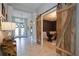 Open hallway with barn doors leading to an office and tile flooring at 9123 Isabella Cir, Parrish, FL 34219